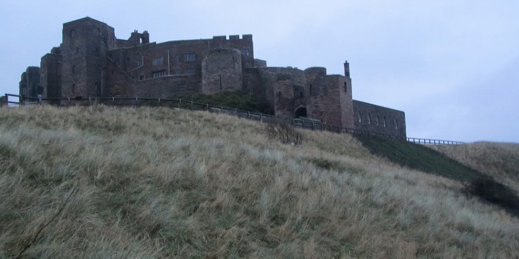 UK - Northumberland - Bamburgh - View of Bamburgh Castle from sand dunes