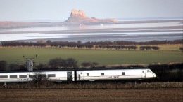 A train regarding the East Coast Line, passes Holy Island